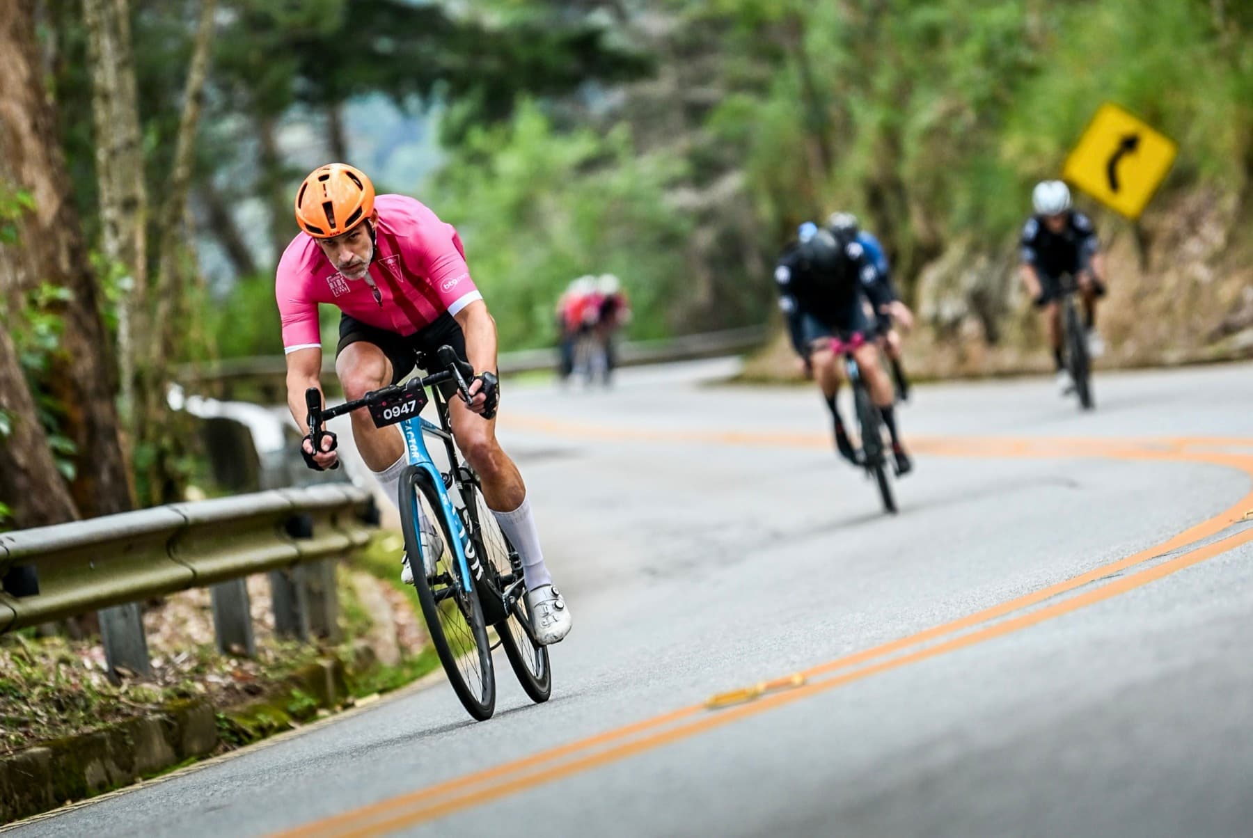 Fernando, SEMIPRO athlete, racing on a winding mountain road.